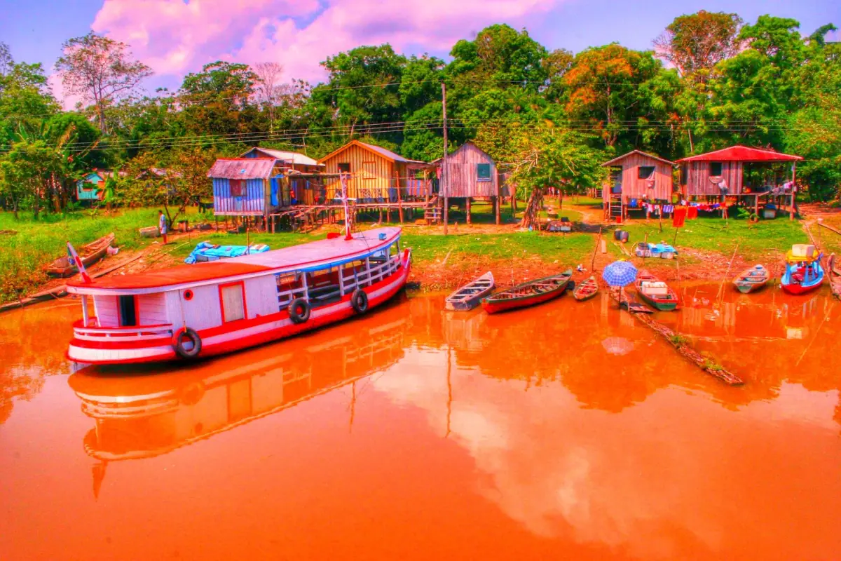 A river boat in front of stilt houses