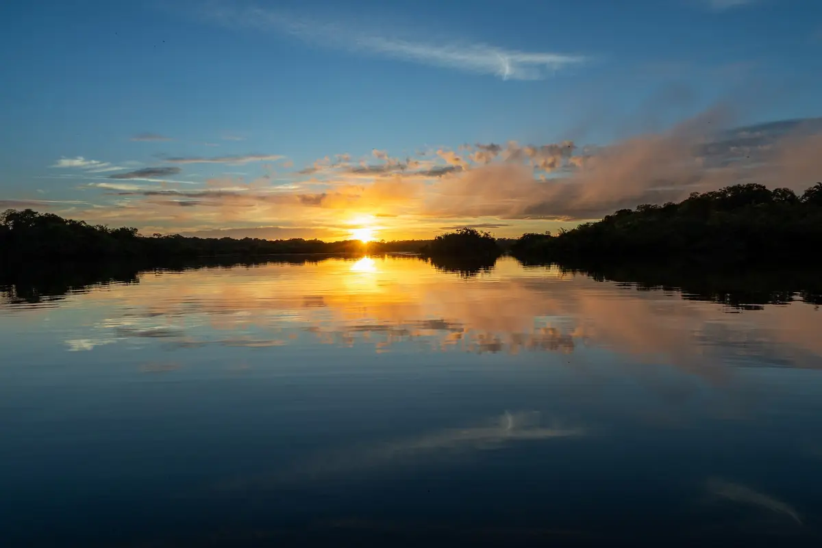 Sunset reflected in calm water in the Amazon