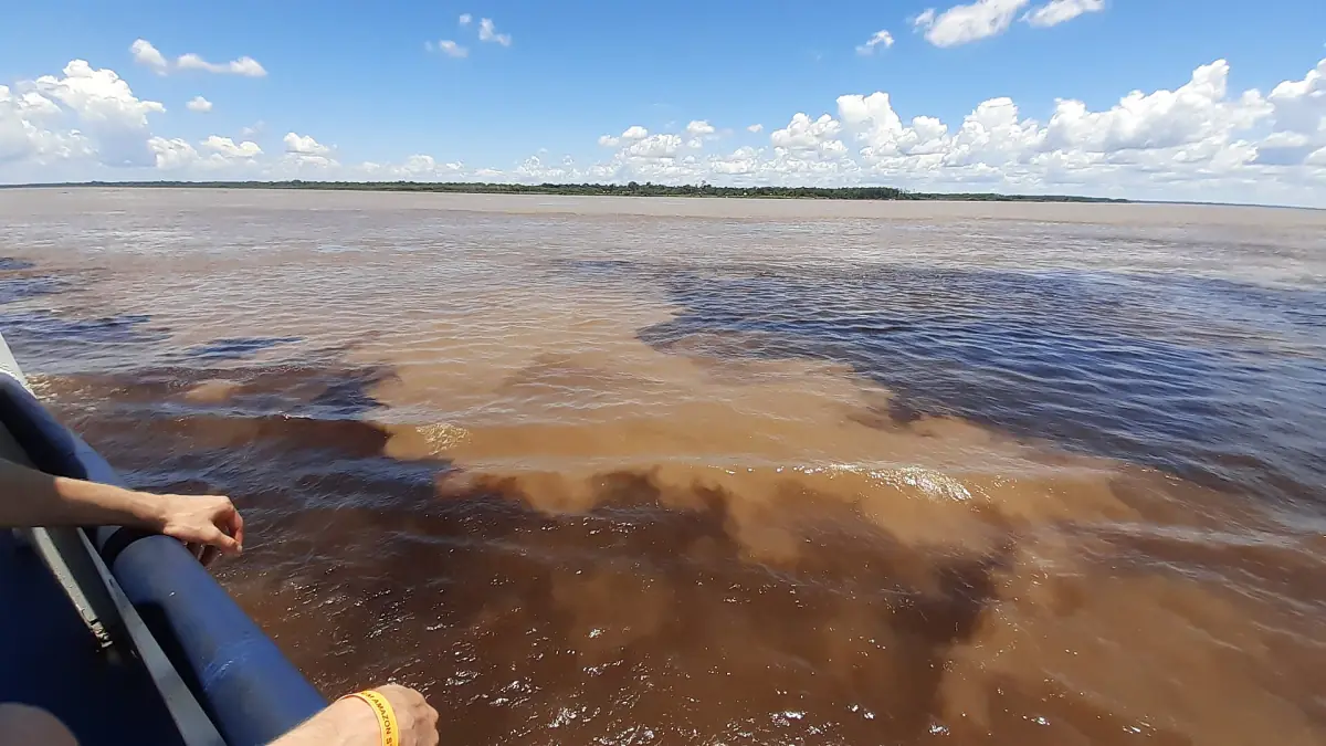 Dark and sandy water side by side at the Meeting of the Waters